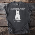 Dark gray t-shirt with white text "DOMESTICATED" above a cat labeled "Fig. 1: Allegedly."