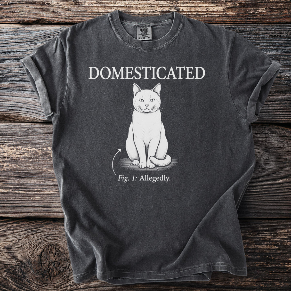 Dark gray t-shirt with white text "DOMESTICATED" above a cat labeled "Fig. 1: Allegedly."