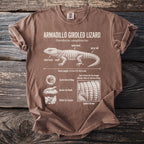 Brown t-shirt with white illustration of armadillo girdled lizard and its traits.