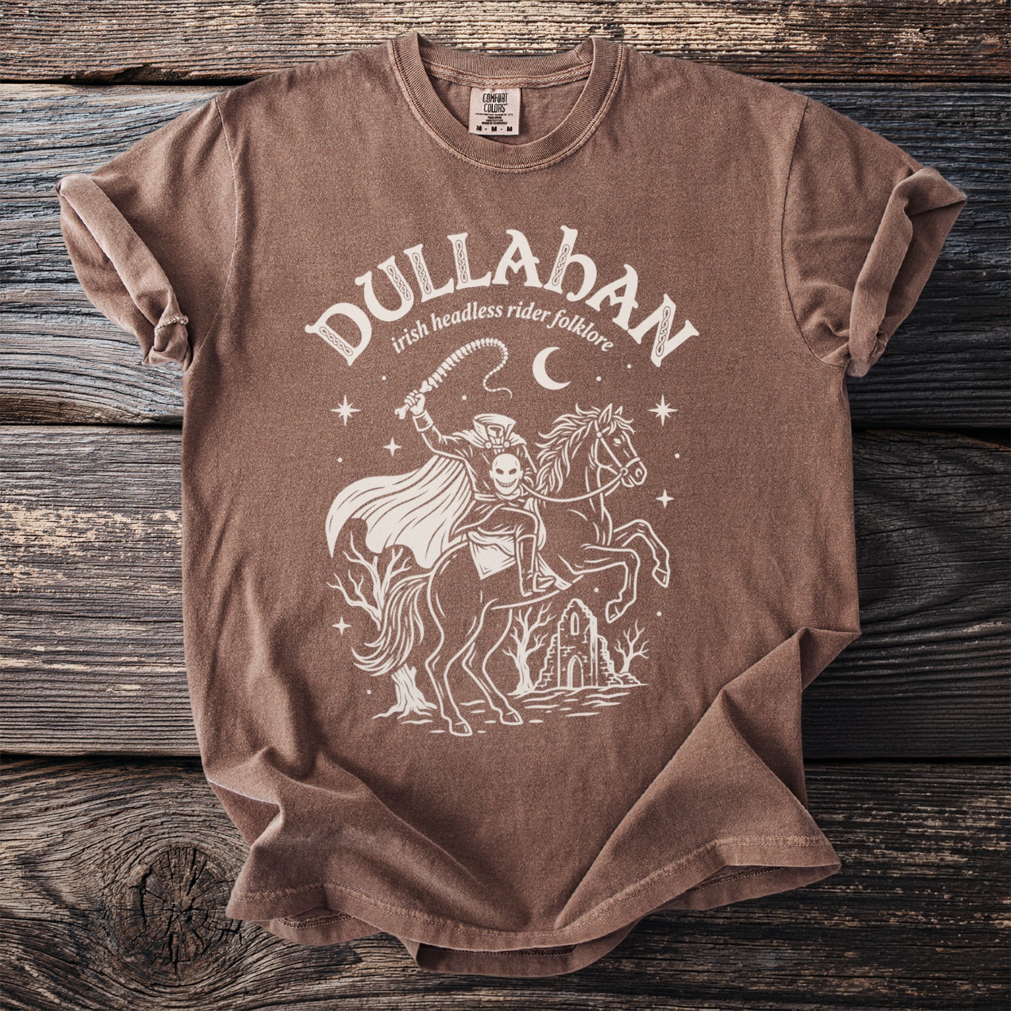Brown t-shirt with white graphic of headless horseman and text "Dullahan irish headless rider folklore."