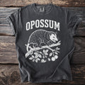 Charcoal t-shirt with white graphic of an opossum on a branch, text "OPOSSUM".