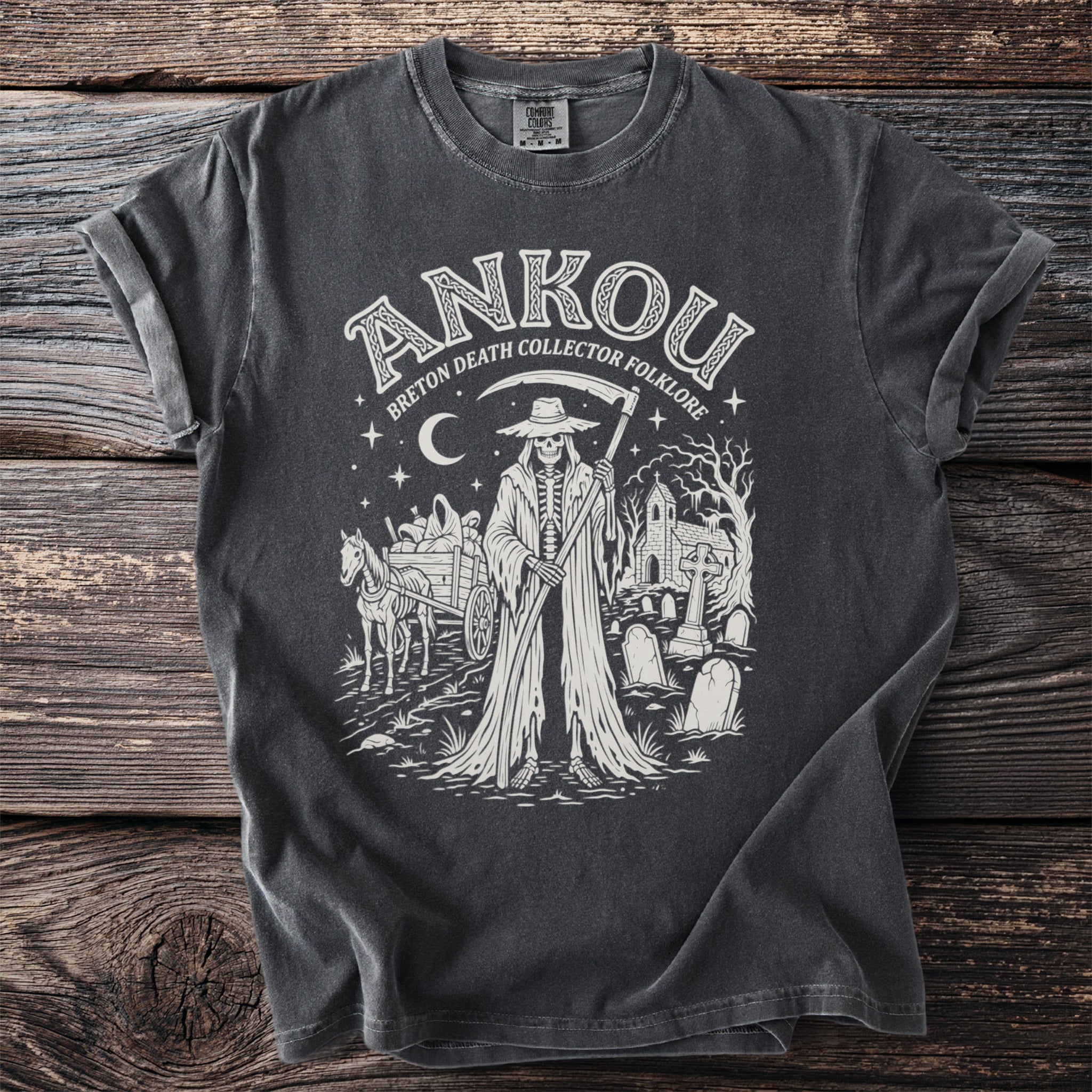 Ankou skeleton reaper with scythe, cart, and cemetery on charcoal t-shirt.