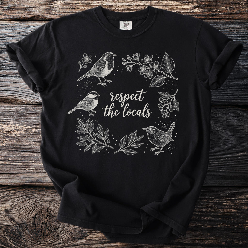 Black t-shirt with a white line drawing of birds and foliage, reading "respect the locals".