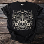 Black t-shirt with a cream-colored dragonflies, moths, moon, and floral design.