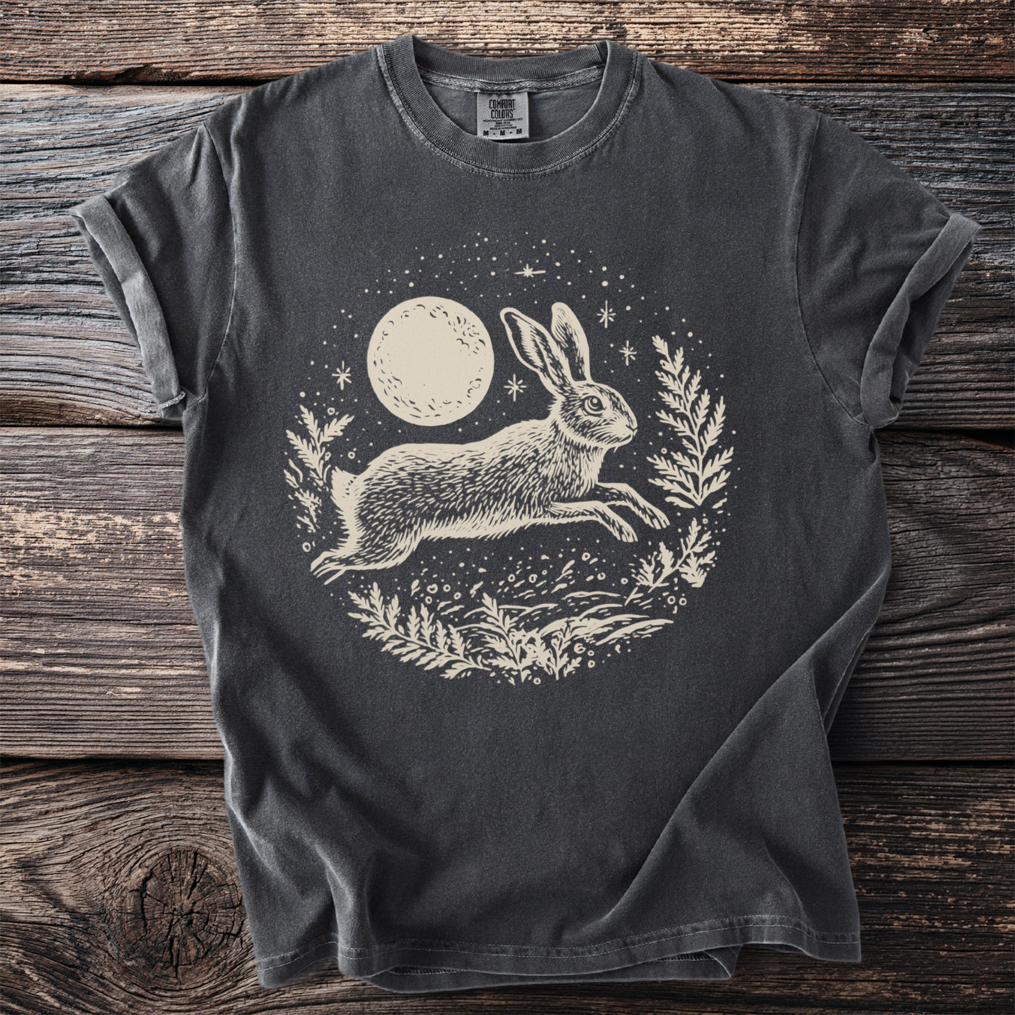 Dark grey t-shirt with a cream-colored graphic of a leaping rabbit under a moon.