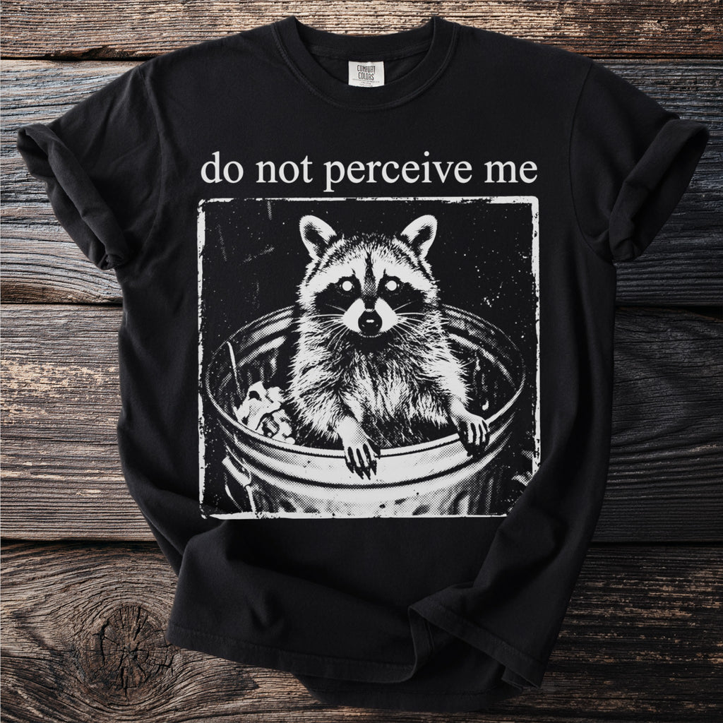Black t-shirt with raccoon in trash can and "do not perceive me" text.