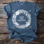 Blue t-shirt with white graphic of sea creatures forming a circle with text "LOVE THE UNLOVED".