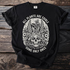 Black t-shirt with skull and floral graphic with text "ALL PLANTS ARE EDIBLE SOME ONLY ONCE".