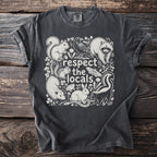 Dark t-shirt with white wildlife illustration and text "respect the locals."