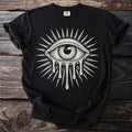 Black t-shirt with a white dripping eye design surrounded by rays.