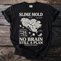 Black t-shirt with "SLIME MOLD NO BRAIN STILL A PLAN" graphic.