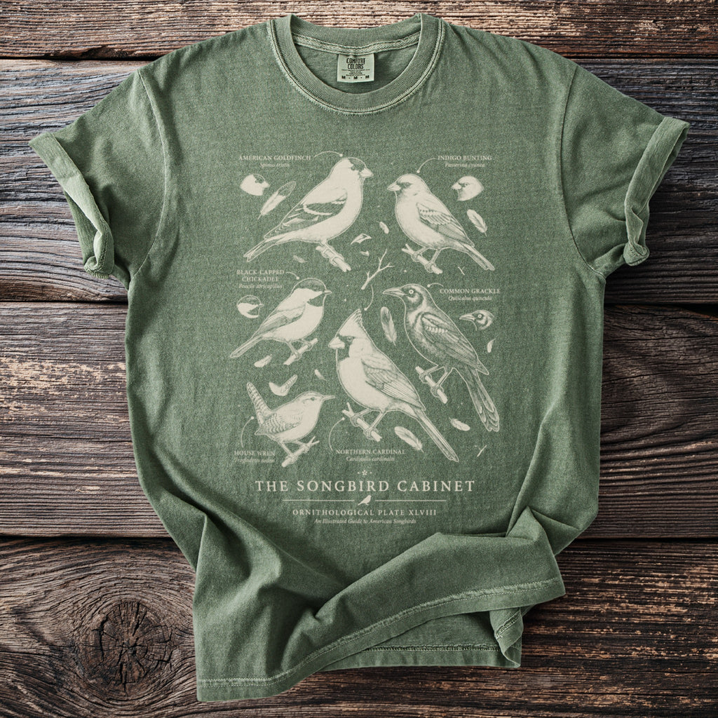 Green t-shirt featuring detailed ornithological illustrations of six songbirds and text.
