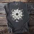 Dark grey t-shirt with white graphic of a circular monster and observatory.