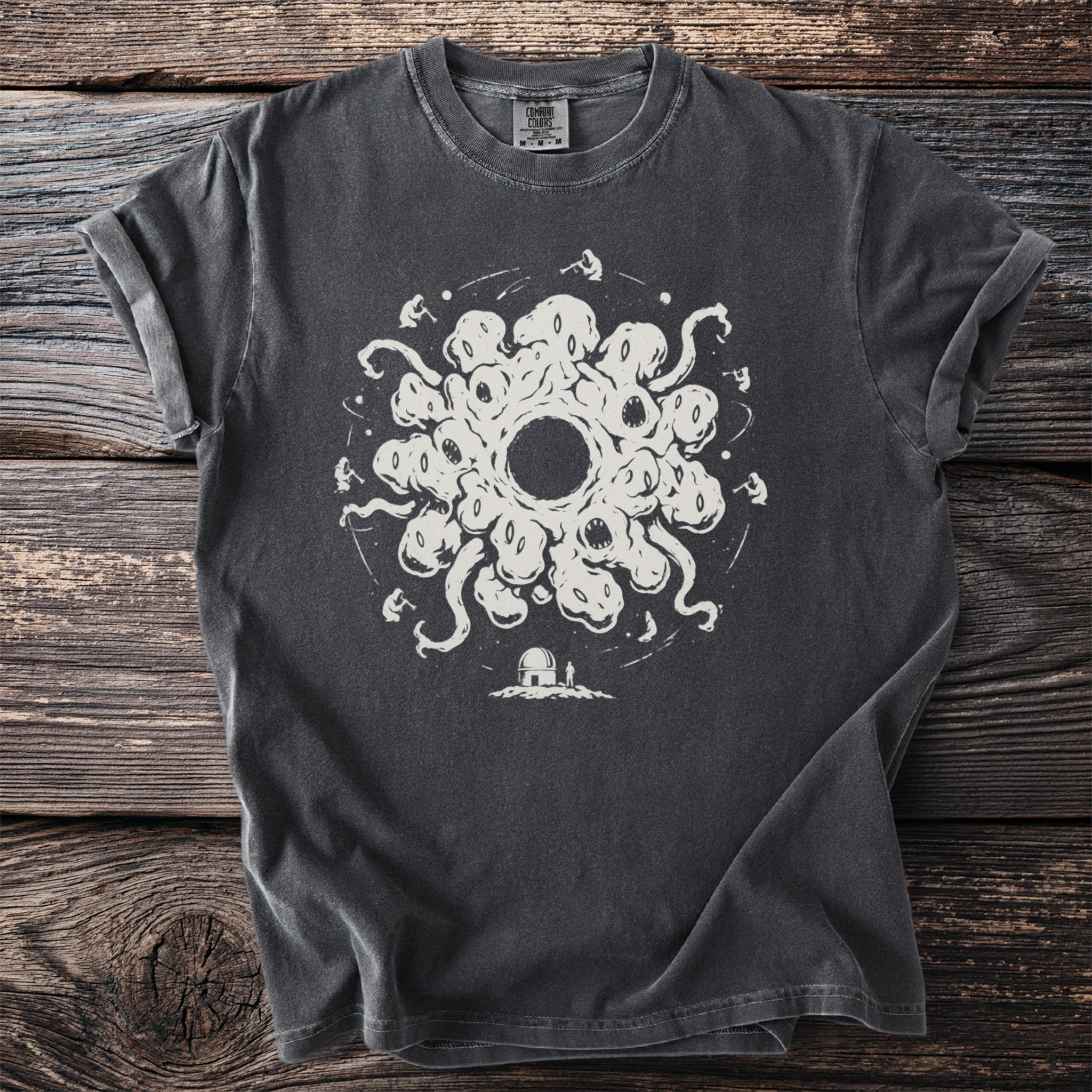 Dark grey t-shirt with white graphic of a circular monster and observatory.