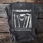 Black t-shirt with a screen print of a kitten peeking from behind books and text, "no thoughts just hiding."