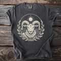 Dark t-shirt with a cream graphic of a ram's head within a laurel wreath.