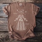 Brown t-shirt with white outline drawing of a witch with plants and text.