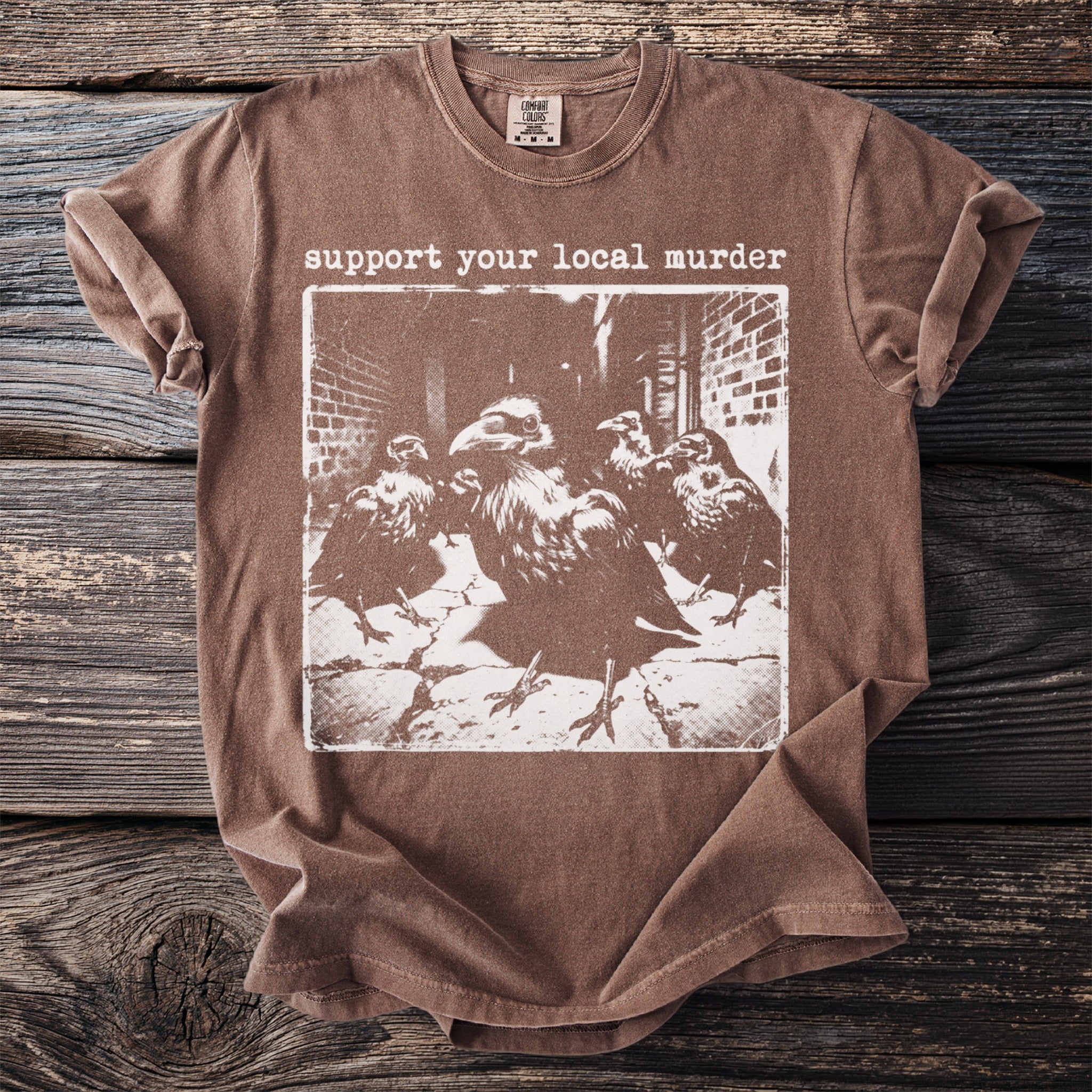Brown t-shirt with graphic of crows and text "support your local murder."