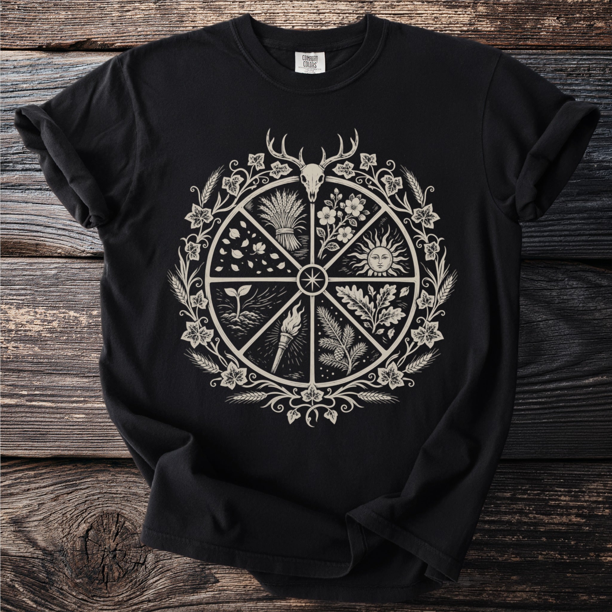 Black t-shirt featuring a circular emblem with a deer skull and nature symbols.