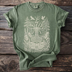 Green t-shirt featuring a Norse hammer design with trees, birds, runes, and candles.