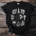 Black t-shirt with witch and botanical illustration design.