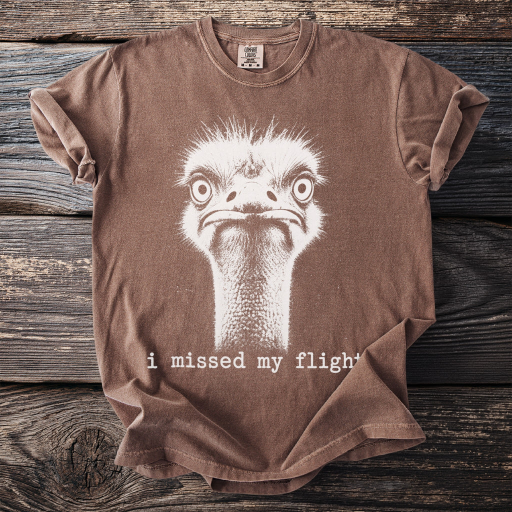 Brown t-shirt with a distressed white ostrich graphic and text "i missed my flight".