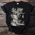 Black t-shirt with a stylized drawing of an old tree stump, ivy, and a hanging lantern.