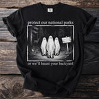 Black t-shirt with ghosts in a forest and text "protect our national parks or we'll haunt your backyard".