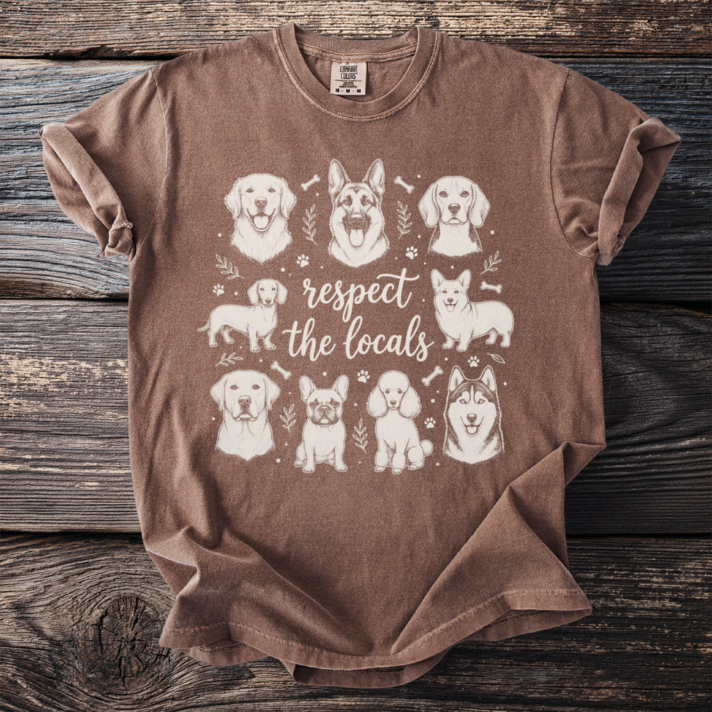 Brown t-shirt with sketch art of various dogs and text "respect the locals".
