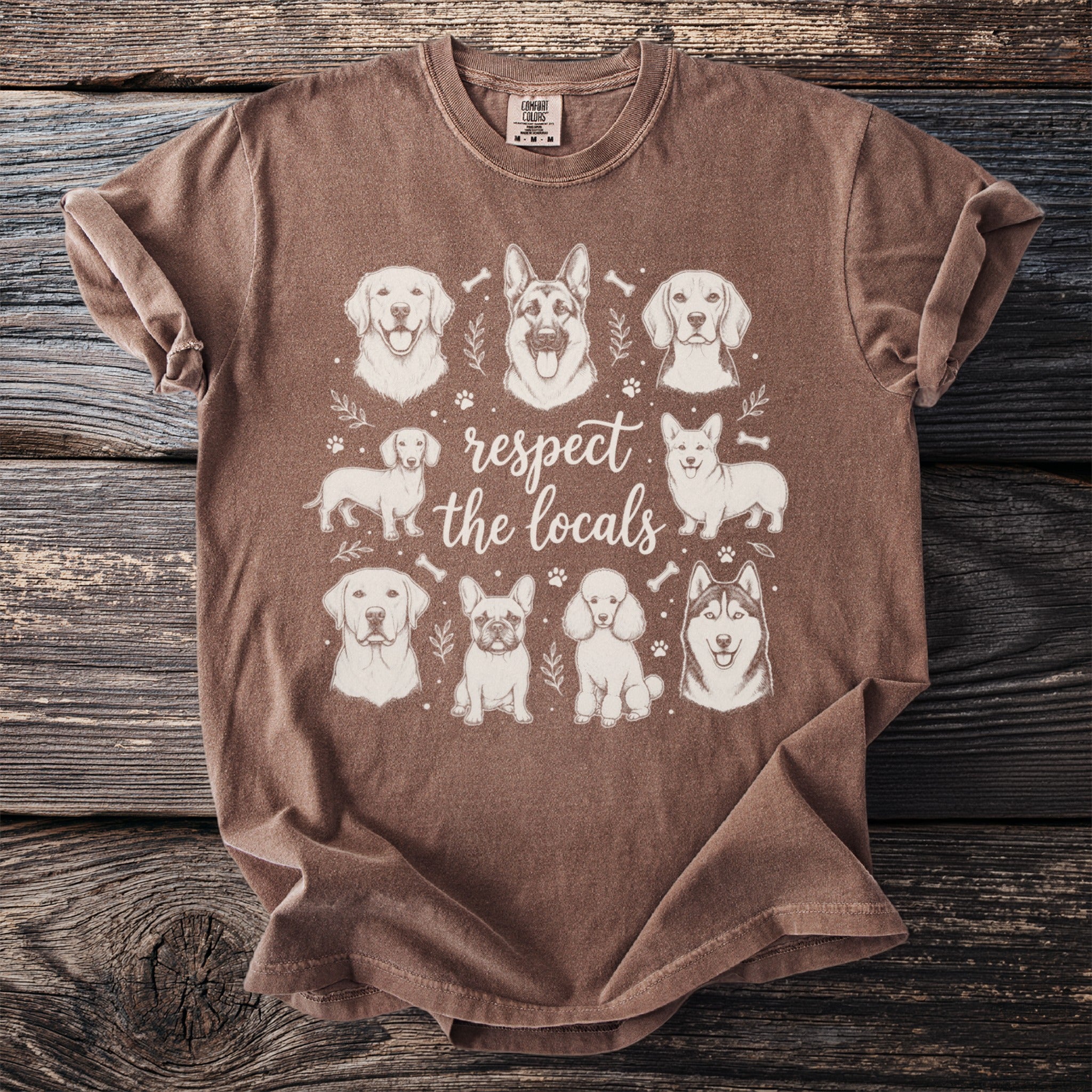 Brown t-shirt with sketch art of various dogs and text "respect the locals".