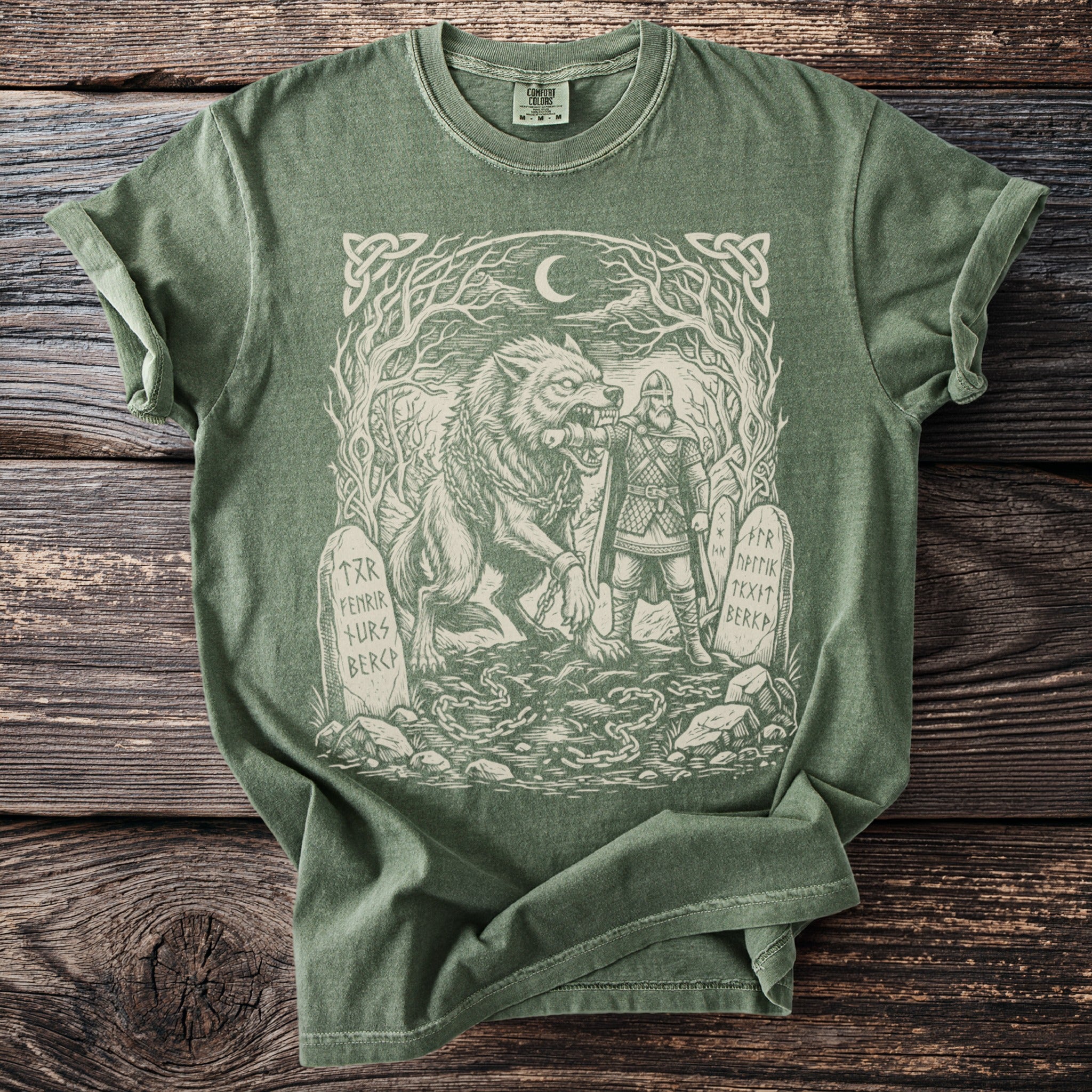 Green t-shirt with Fenrir wolf and warrior graphic, and rune-inscribed stones.