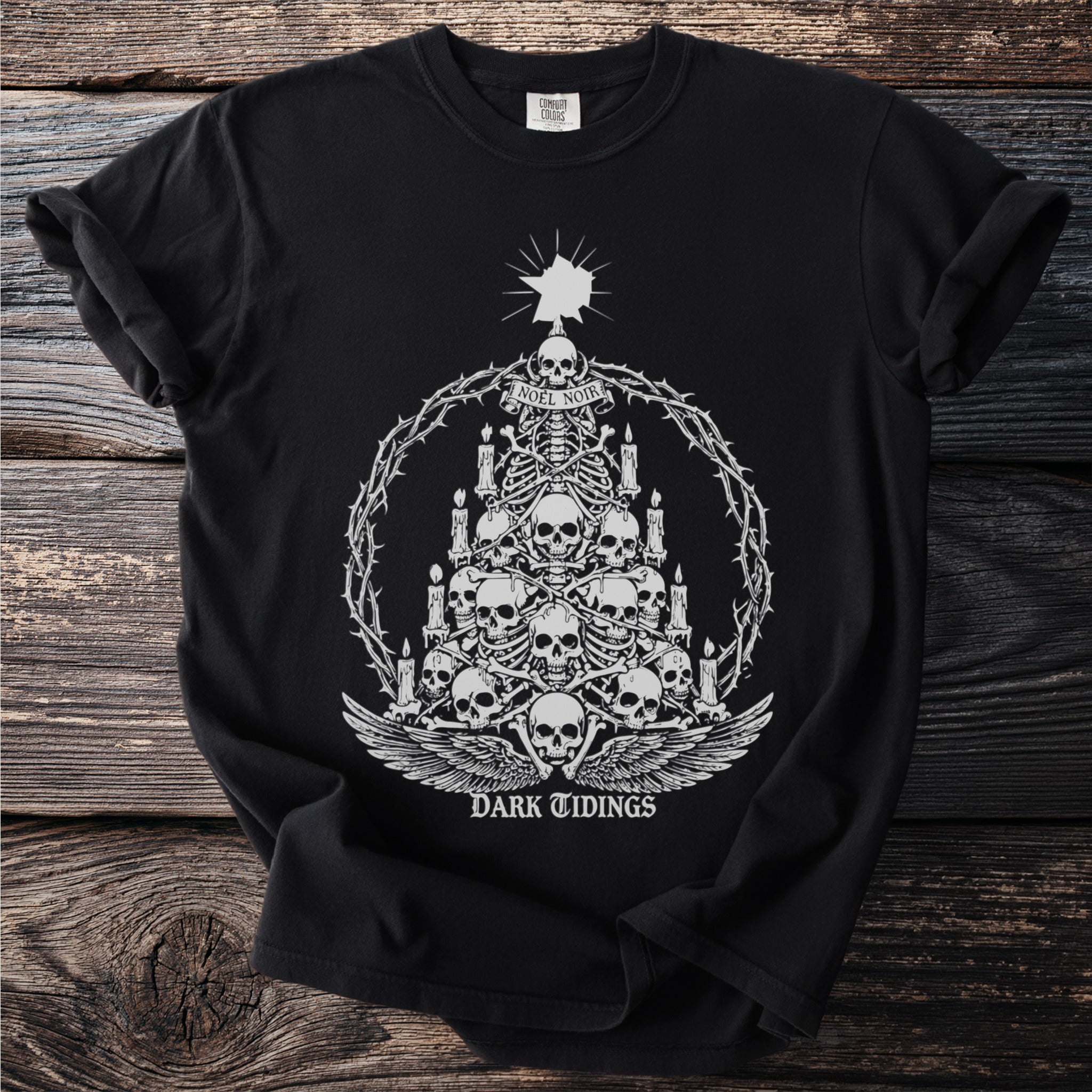 Black t-shirt with skeleton Christmas tree design and text "NOEL NOIR DARK TIDINGS".