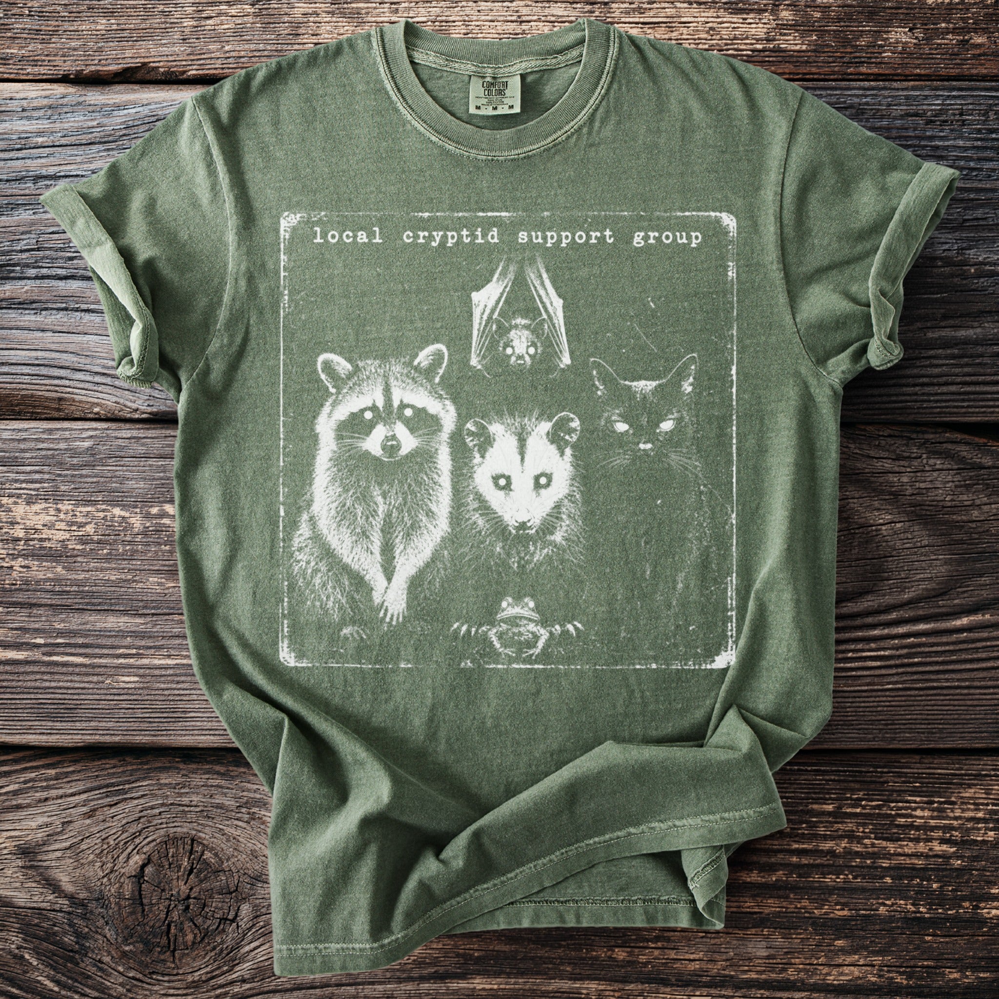 T-shirt with a distressed graphic of a raccoon, opossum, cat, bat, and frog.