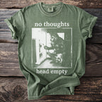 Green t-shirt with white text "no thoughts head empty" and wolf image.