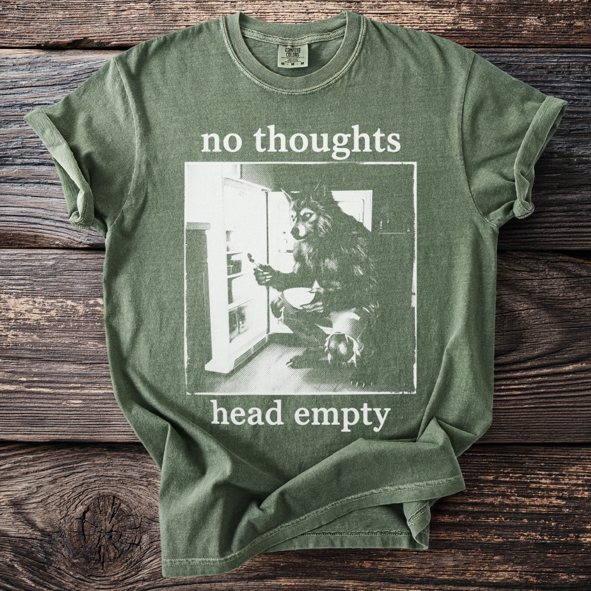Green t-shirt with white text "no thoughts head empty" and wolf image.