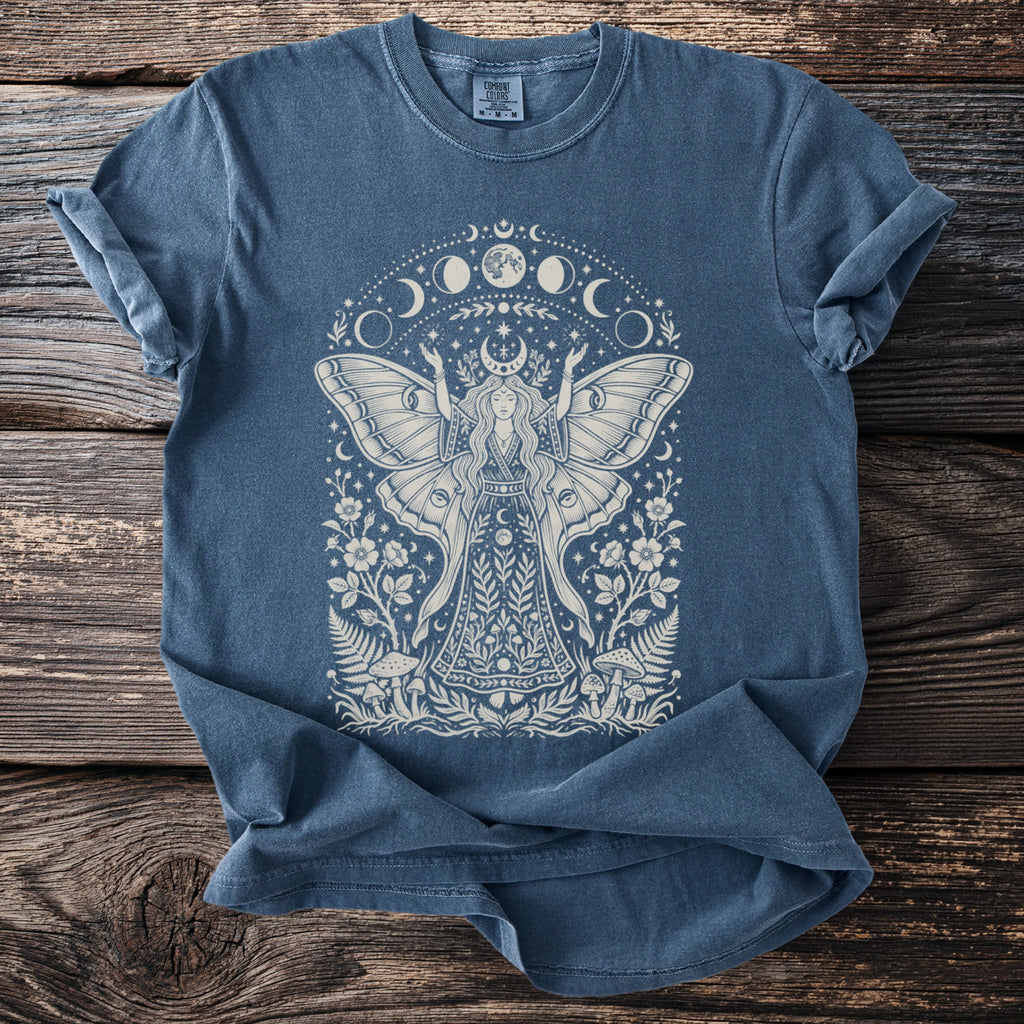 Blue t-shirt with moth fairy, mushrooms, flowers, and moon phase graphic design.