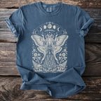 Blue t-shirt with moth fairy, mushrooms, flowers, and moon phase graphic design.