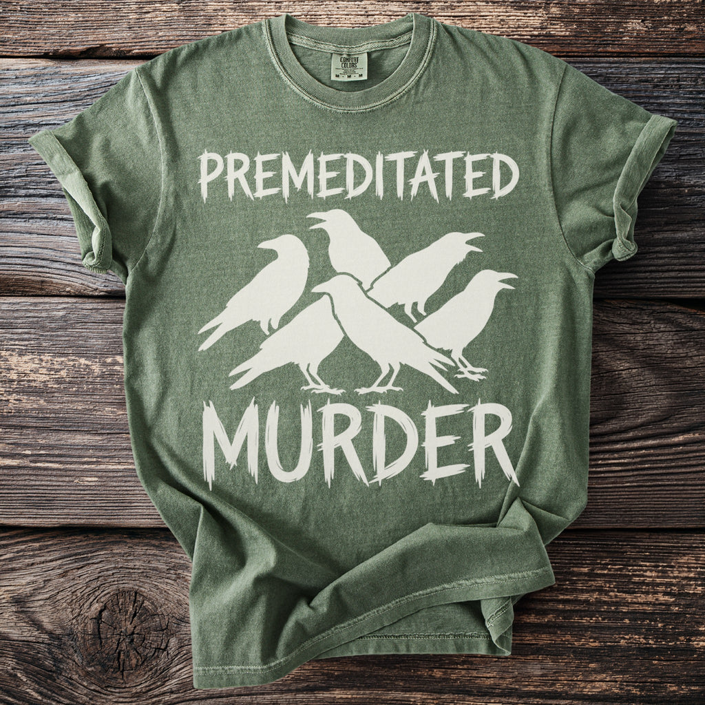 Green t-shirt with white text "PREMEDITATED MURDER" and silhouette of five crows.