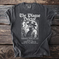 Black t-shirt with "The Plague Doctor" and a medieval doctor illustration.