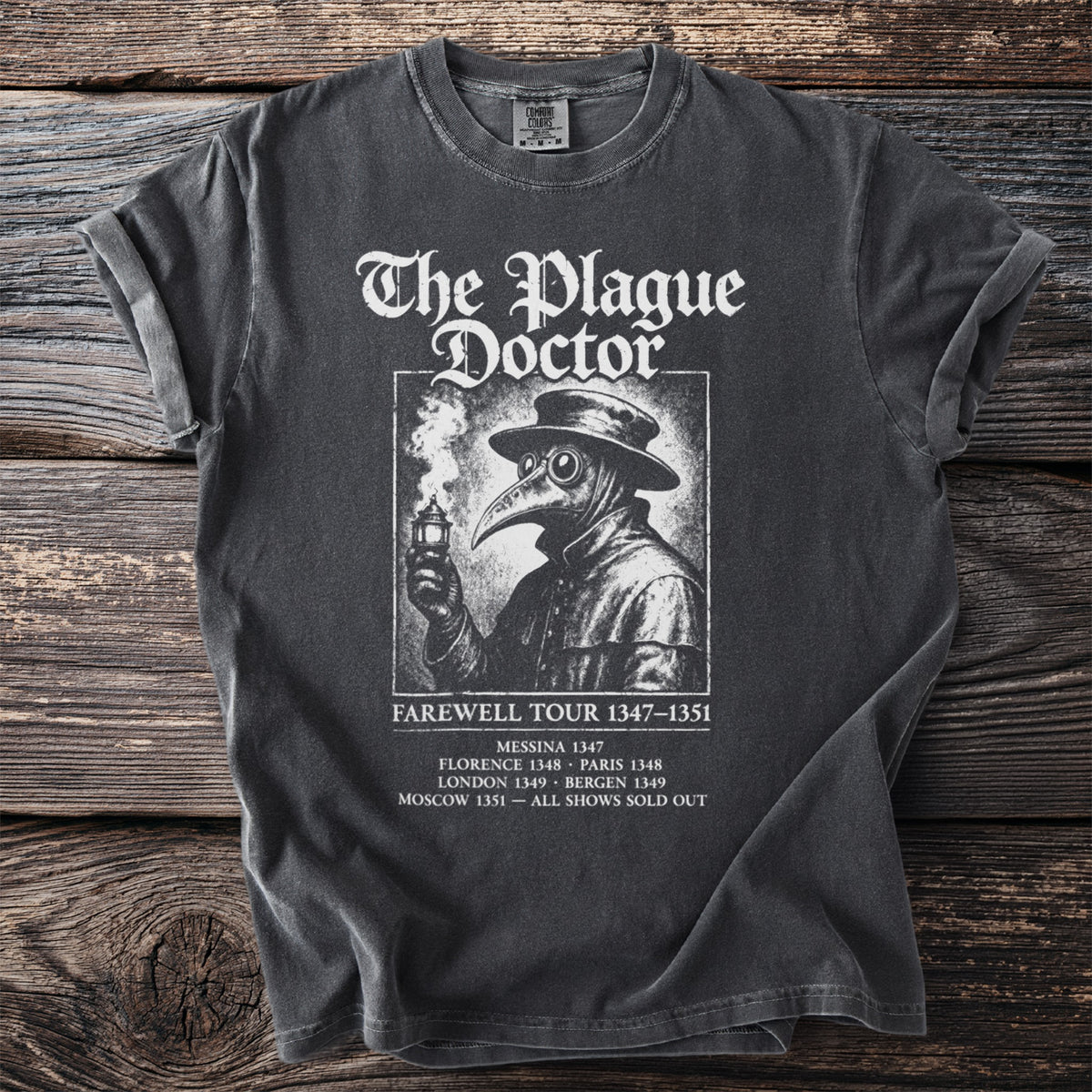 Black t-shirt with "The Plague Doctor" and a medieval doctor illustration.