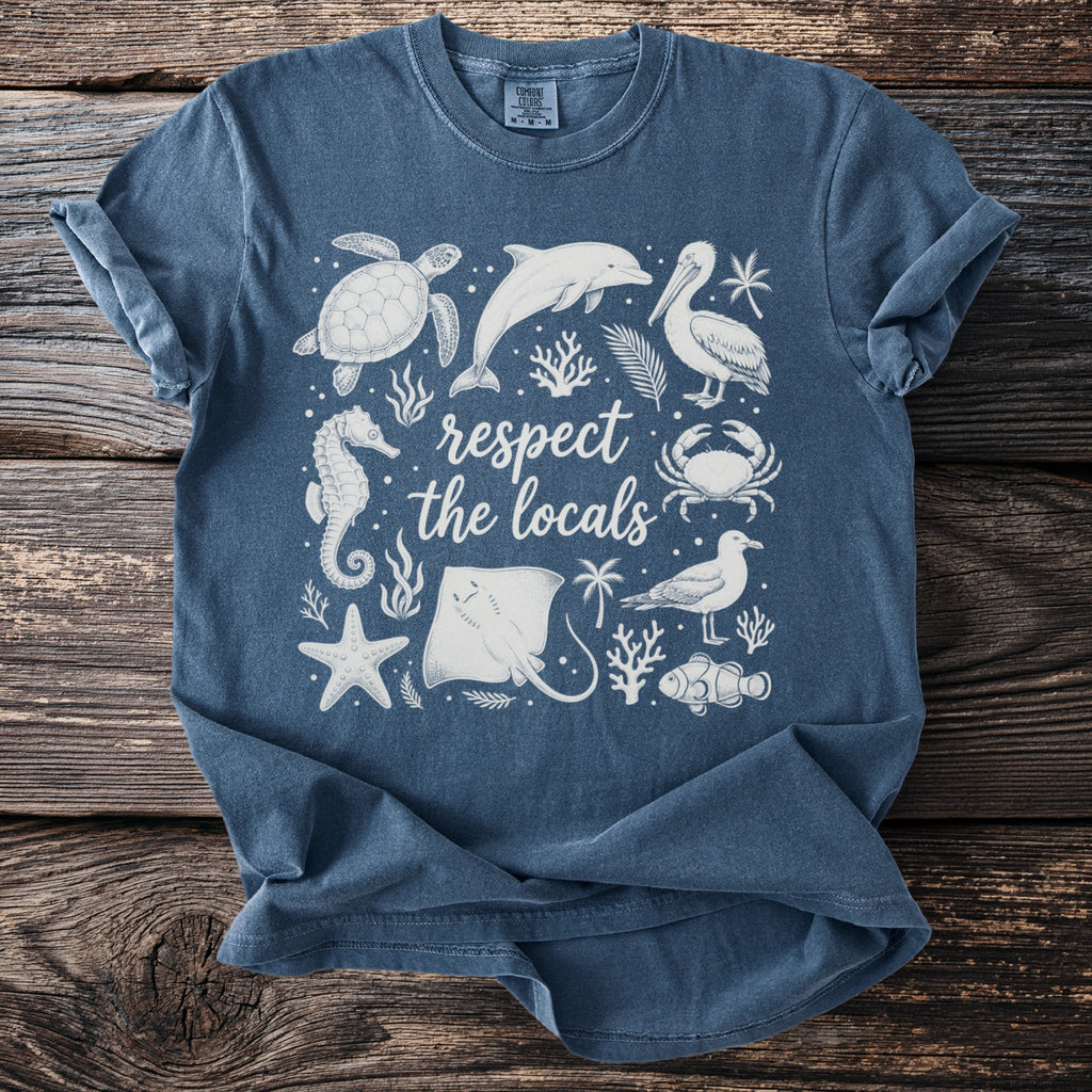 Blue t-shirt with white sea creatures and text "respect the locals".