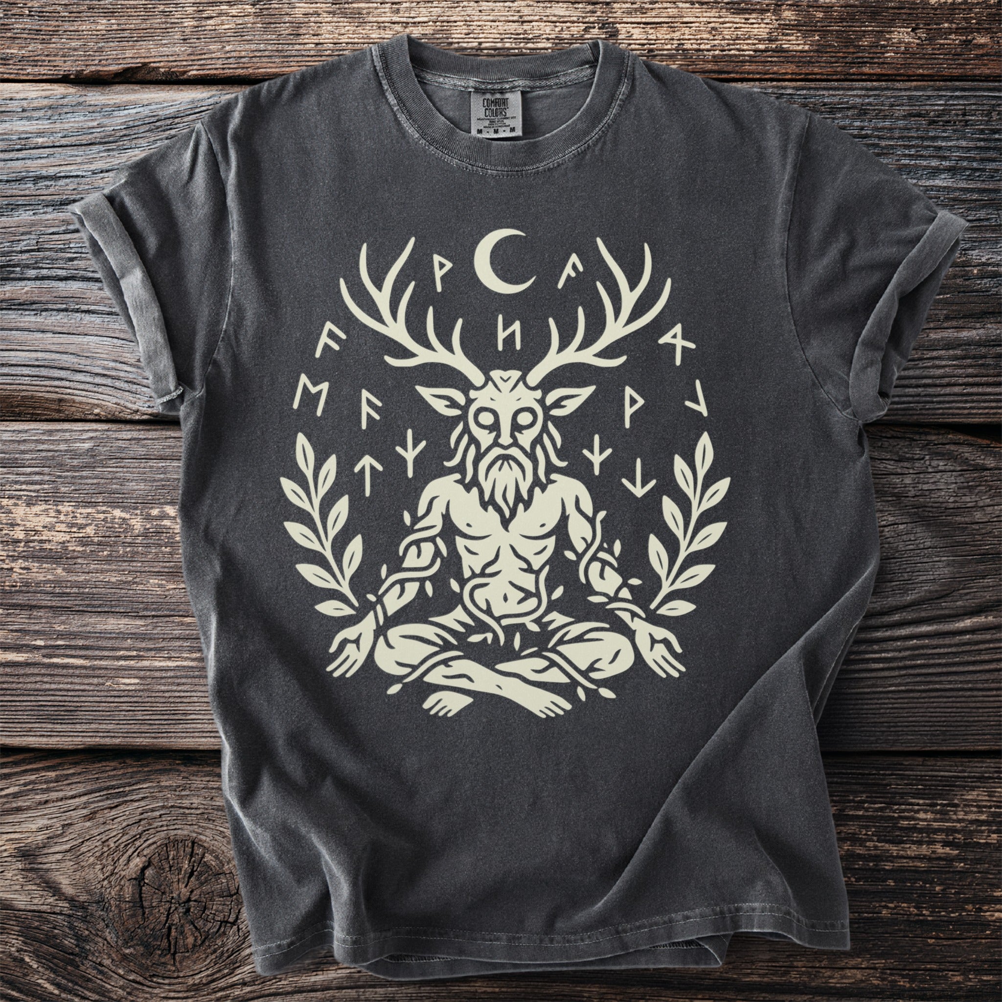 Dark grey t-shirt with a light graphic of a horned figure surrounded by runes and leaves.
