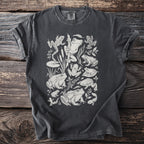 Dark gray t-shirt with a white linework print of various frogs and tadpoles.