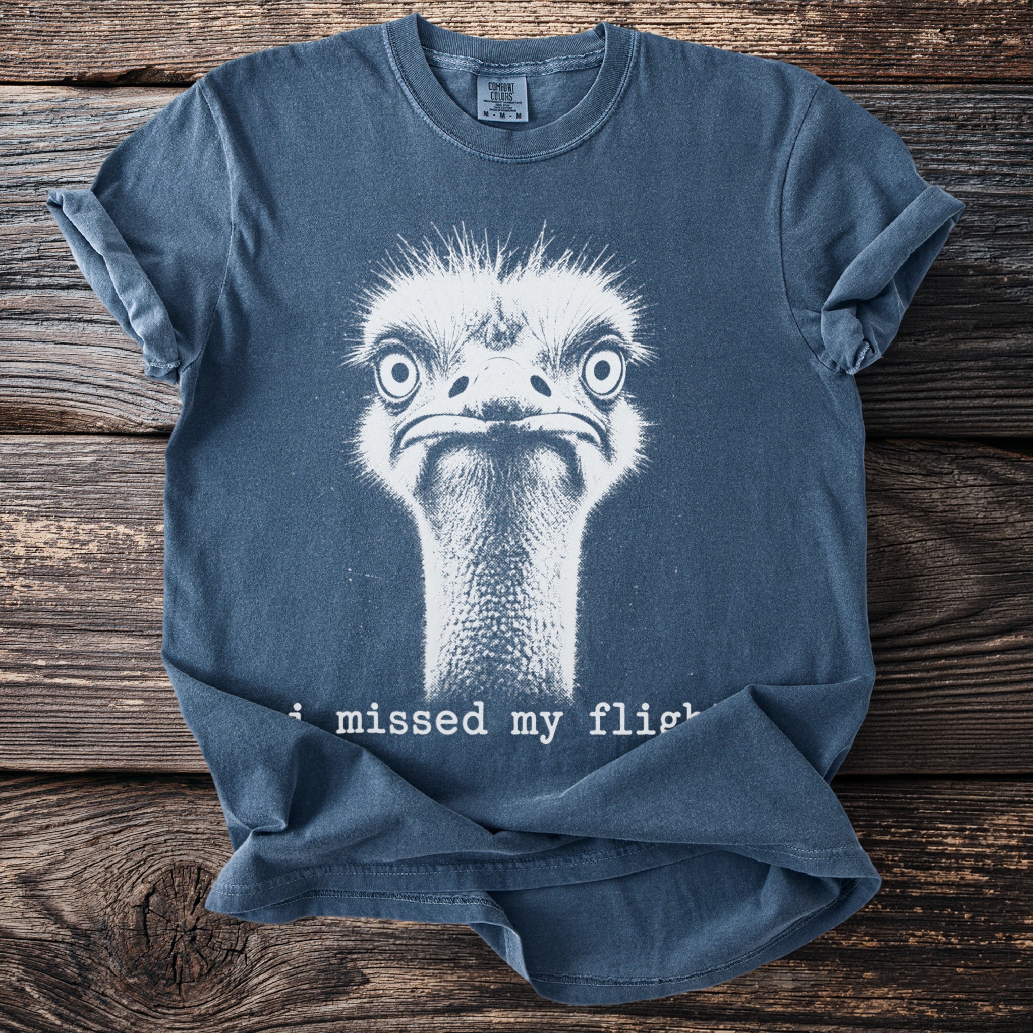 Blue t-shirt with white distressed ostrich graphic and "i missed my flight" text.