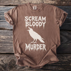 Brown t-shirt with white crow and "Scream Bloody Murder" text.