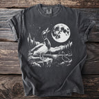 Graphic tee with two ducks and a moon above a starry, mountainous landscape by a lake.