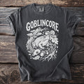 Dark gray t-shirt with white "Goblinore" text and forest creature graphic.