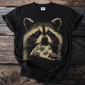 Black t-shirt with a tan graphic of a raccoon eating a slice of pizza.