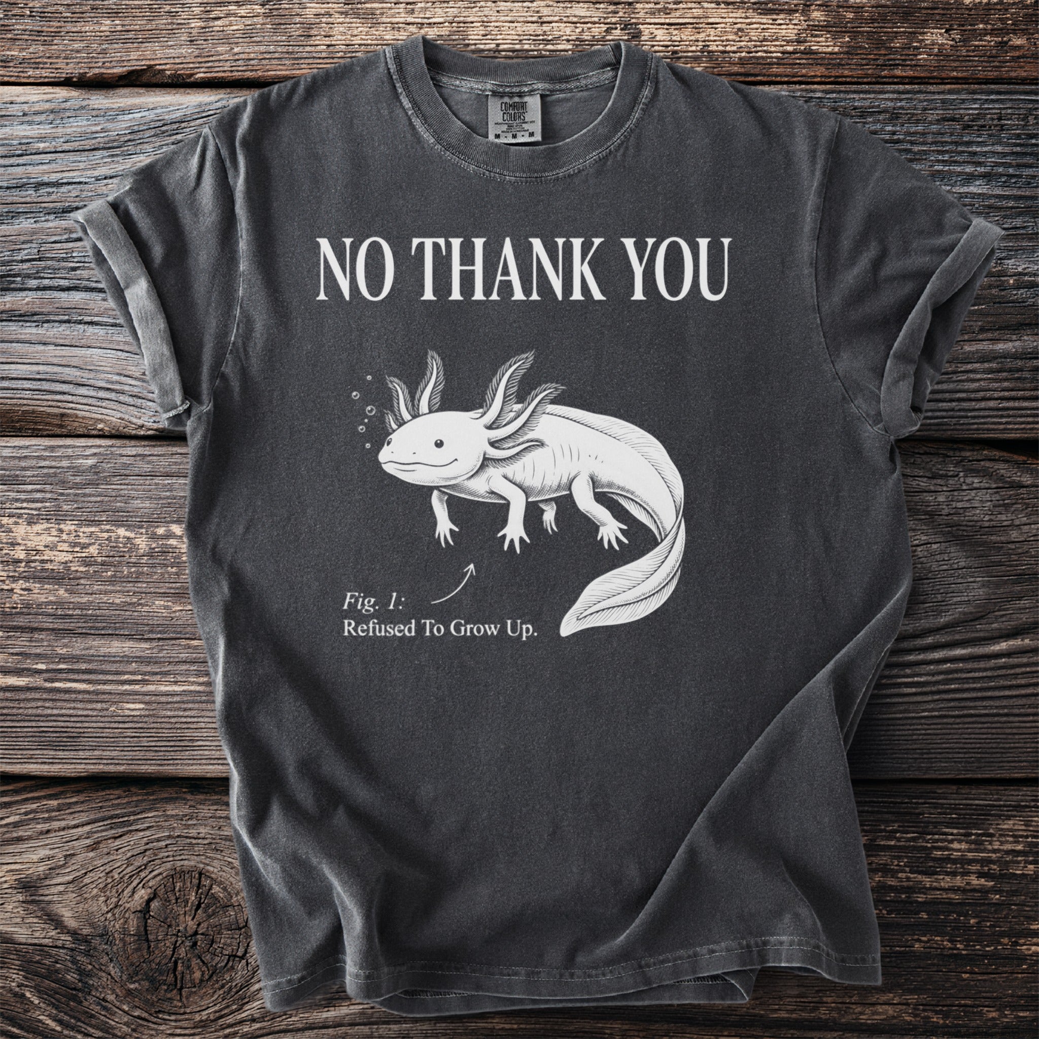 Dark gray t-shirt with axolotl graphic and text "NO THANK YOU Fig. 1: Refused To Grow Up."