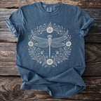 Blue t-shirt with a white dragonfly and floral wreath graphic.